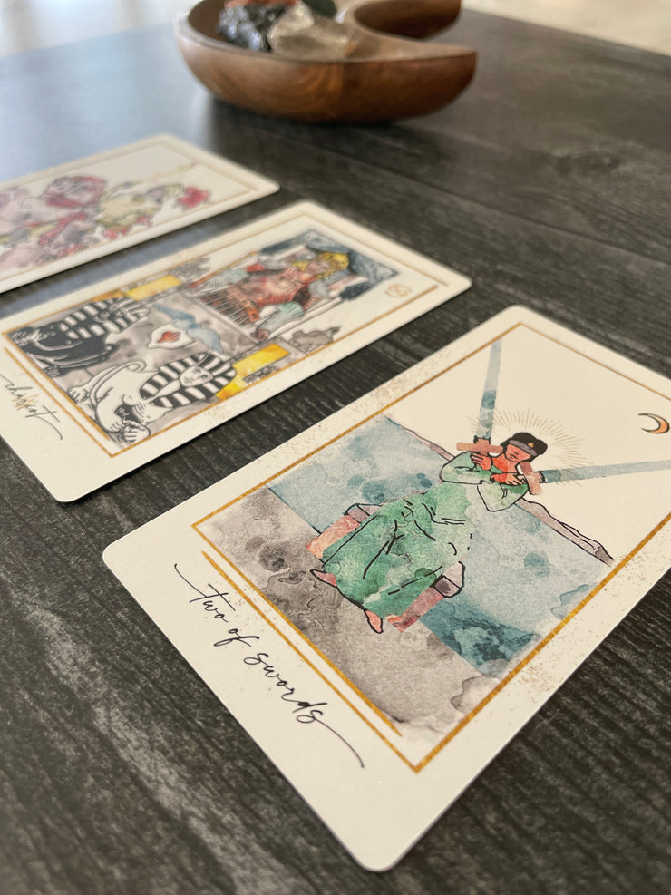 Vintage-style tarot cards on a wooden surface