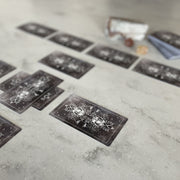 Tarot cards laid out on a textured surface with a blurred background