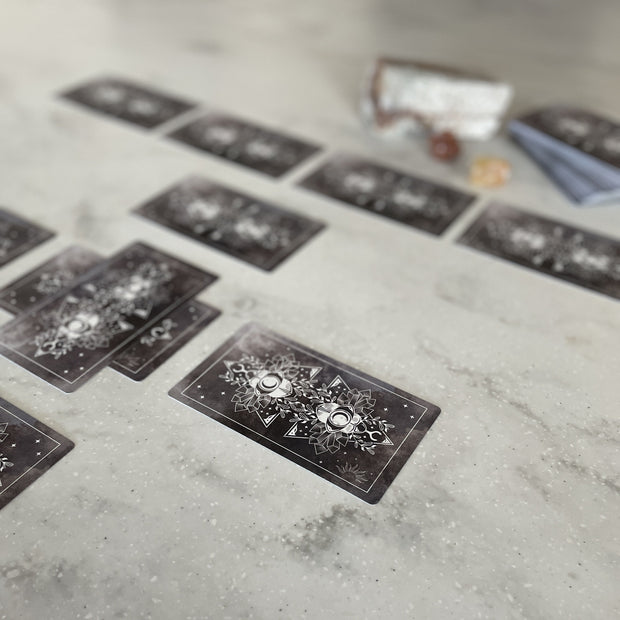 Tarot cards laid out on a textured surface with a blurred background
