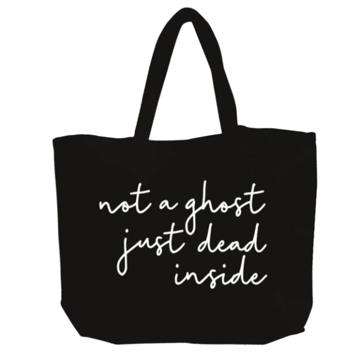 Black tote bag with white text 'not a ghost just dead inside' on a white background
