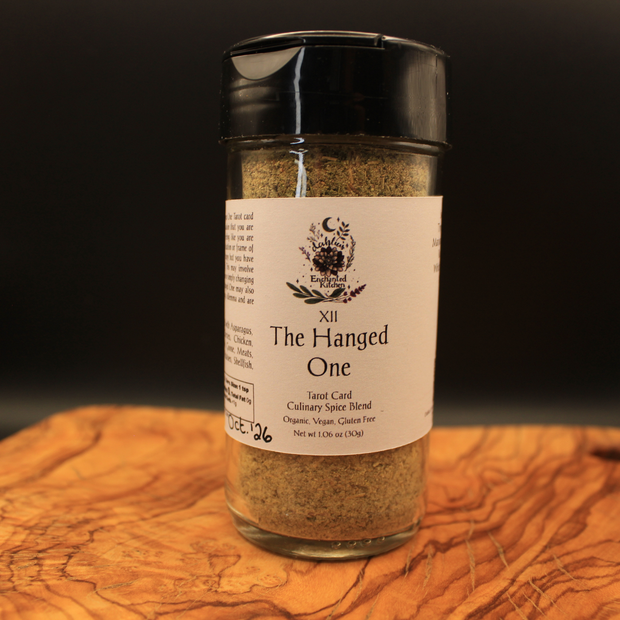 Spice blend jar labeled 'The Hanged One' on a wooden surface with a dark background