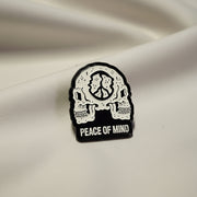 Black and white skull design with 'Peace of Mind' text on a beige background