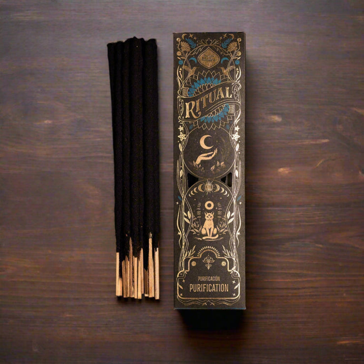 Incense sticks with decorative packaging on a wooden surface
