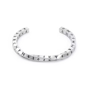 Silver bracelet with engraved rune symbols on a white background