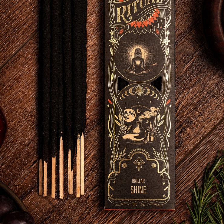 Ritual incense packaging with incense sticks on a wooden surface