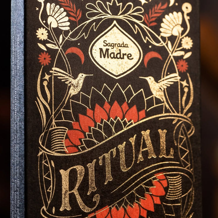 Decorative box with 'Sagrada Madre Ritual' text and intricate designs on a dark background
