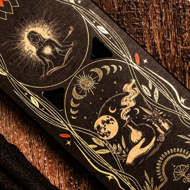 Decorative packaging with celestial designs on a wooden surface