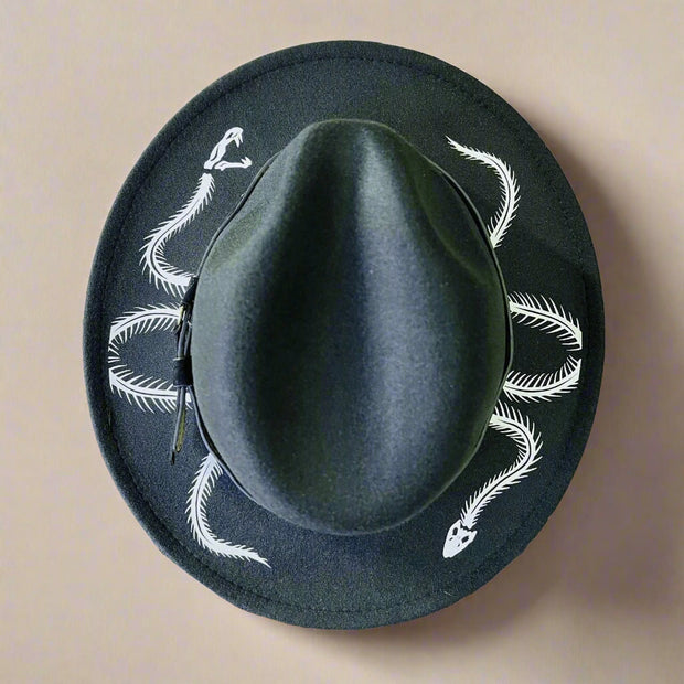 Black hat with white snake skeleton designs on a white background