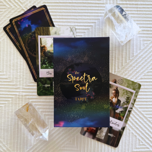 Tarot cards with 'The Spectra Soul Tarot' book on a textured surface