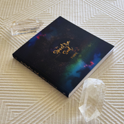 Book titled 'The Spectral Soul' on a textured surface with crystals around