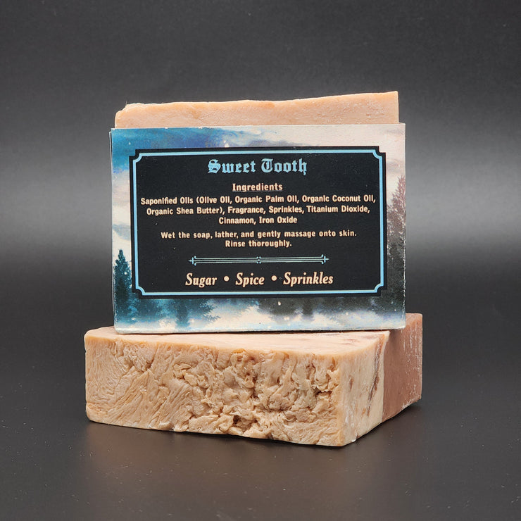 Bleak Boutiques Sweet Tooth Handmade Vegan Bar Soap (SEASONAL) is shown: two marbled bars, one upright with a Sugar • Spice • Sprinkles label, offering delightful scents and handcrafted appeal.