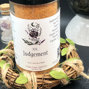 Jar of Tarot Card Spice Blend "Judgement" by Dahlia's Enchanted Kitchen surrounded by foliage and crystals