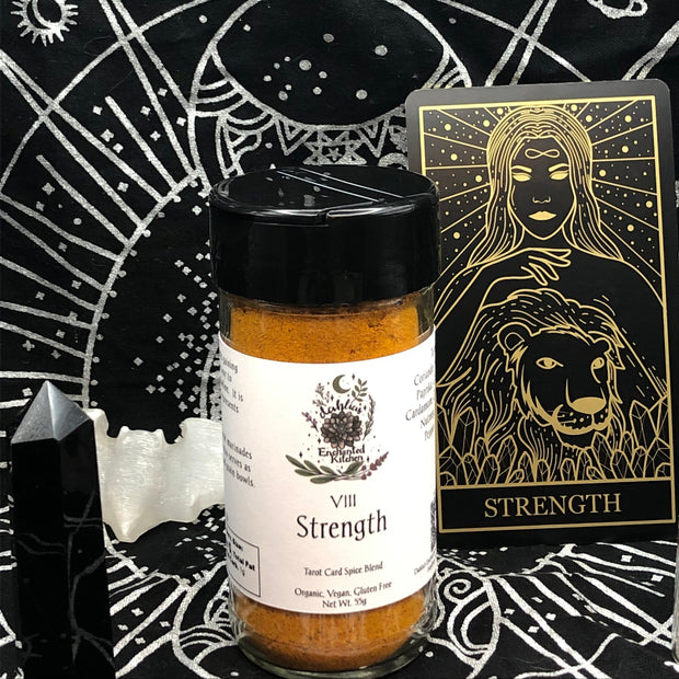 Tarot Card Spice Blend "Strength" by Dahlia's Enchanted Kitchen in front of the Strength tarot card.