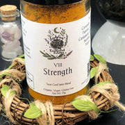 Tarot Card Spice Blend "Strength" by Dahlia's Enchanted Kitchen pictured surrounded by crystals and a wreath