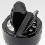 a black spice jar lid showing two openings on a white background.