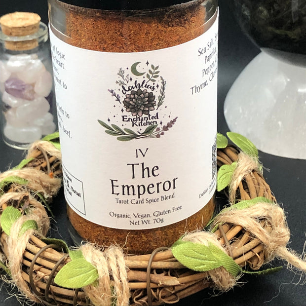 Spice blend jar labeled 'The Emperor' from Dahlia's Enchanted Kitchen on a dark background with decorative elements.