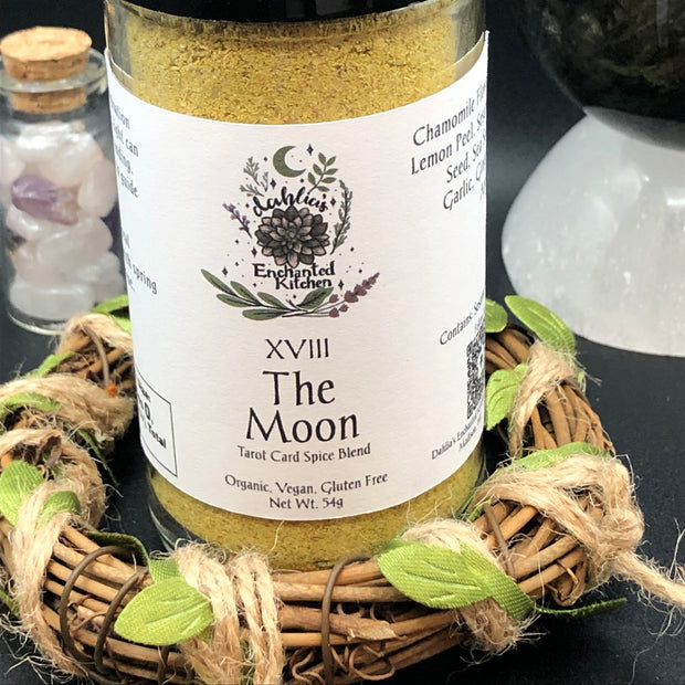 Tarot Card Spice Blend "The Moon" by Dahlia's Enchanted Kitchen surrounded by floral elements and crystals