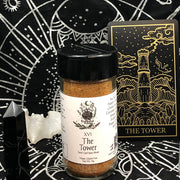 Tarot Card Spice Blend "The Tower" by Dahlia's Enchanted Kitchen surrounded by tarot themed items.
