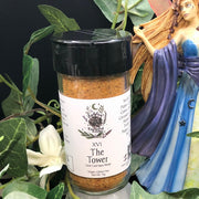 Tarot Card Spice Blend "The Tower" by Dahlia's Enchanted Kitchen with foliage and a fairy statue in the background.
