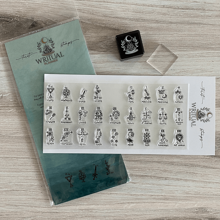 Set of Tarot stamps on a wooden surface with packaging.