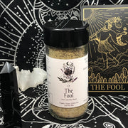Spice blend jar labeled 'The Fool' on a mystical-themed background with astrological symbols.