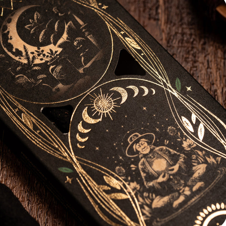 Decorative packaging with celestial designs on a wooden surface