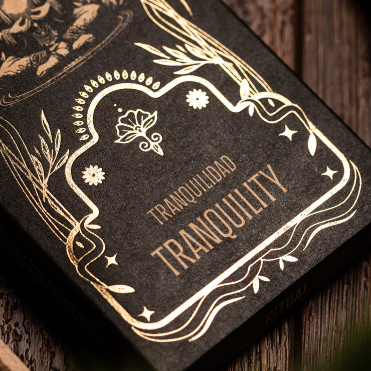 Decorative product packaging with 'TRANQUILIDAD' text on a dark background