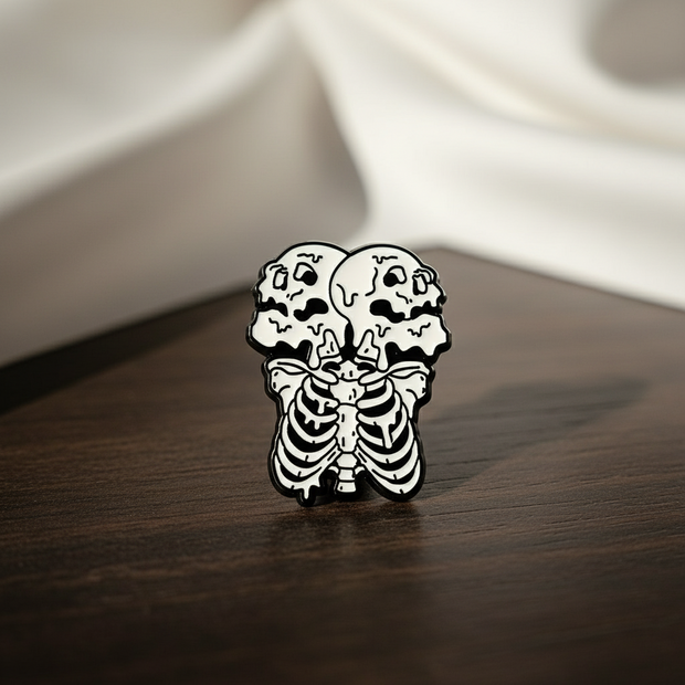 Two Heads Enamel Lapel Pin depicting a skeleton with two heads on a wood background