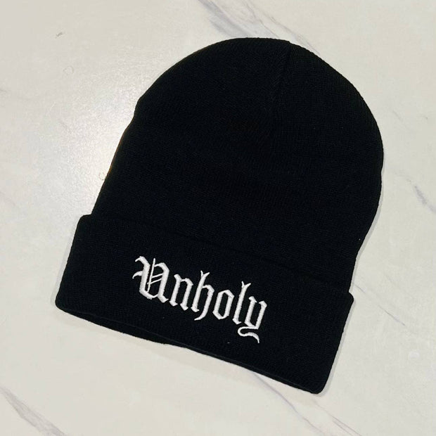 Black beanie with 'Unholy' embroidery on a white background