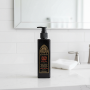 Black Bleak Boutique liquid soap bottle with pump on a bathroom counter