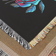 Intriguing Crow and Flowers Woven Throw Blanket with a crow in shades of black and blue against a dramatic background of magenta splashes and abstract shapes. Perfect for wall decoration, a cozy throw, or a unique picnic spread.