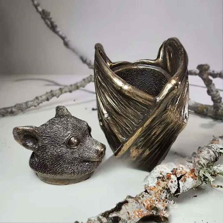 Meticulously crafted Flying Fox Bat Keepsake Stash Storage Box, hand-painted in rich bronze, 5 inches tall and 3-inch diameter, perfect for safeguarding jewelry or small treasured items, adding a touch of mystery and charm to any gothic decor.