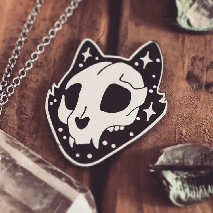 Intricately designed Gothic Cat Skull Enamel Lapel Pin featuring a high gloss silver chrome finish, with the cat's face and ears outlined in striking black enamel and gloss silver star accents.