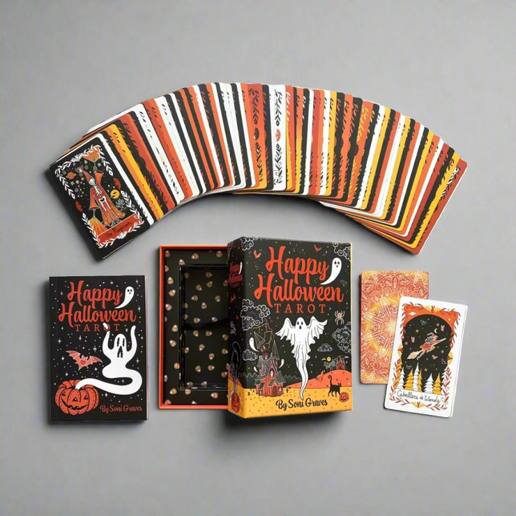 Happy Halloween Tarot Card Deck & Guidebook Set featuring vintage Halloween art like skeletons, witches, pumpkins, and bats designed by Soni Graves. Includes 128-page illustrated guidebook with custom spreads. 