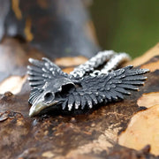 Meticulously detailed Wings of the Raven Skull Stainless Steel Pendant Necklace crafted from high-quality 316L stainless steel with an antiqued finish, showcasing an intricately designed raven skull and wings.