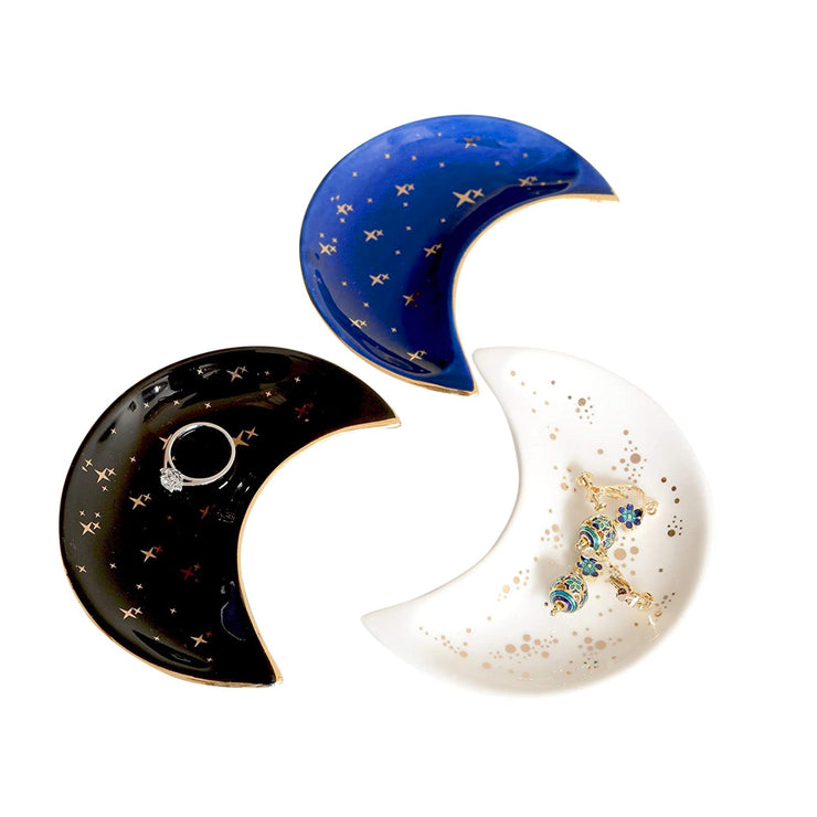 The Bleak Boutique Crescent Moon Ceramic Jewelry Valet Dish features a black, blue, or white glaze with gold star accents, displayed on a white background—ideal for holding jewelry or small trinkets.