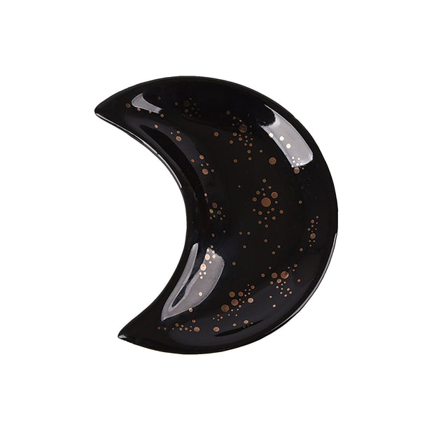 The Crescent Moon Ceramic Jewelry Valet Dish by Bleak Boutique features a glossy black crescent moon shape decorated with gold dots and speckles, making it an ideal trinket holder or jewelry caddy.